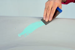 3M Acryl Putty being applied to a small automotive chip demonstrating smooth spreadability