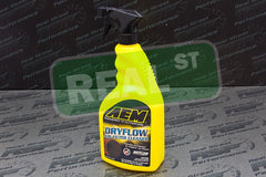 AEM cleaner sprayed onto synthetic air filter to loosen grime and restore airflow