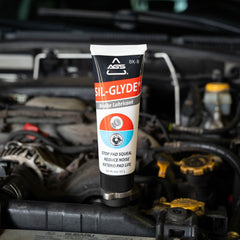 AGS SIL-Glyde tube in hand displaying 8 oz scale for easy storage and application