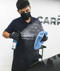 Detailer wiping car paint with CARPRO Eraser before ceramic coating application