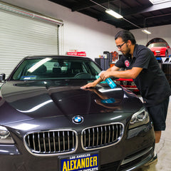 Chemical Guys clay bar in use on car door for smooth finish