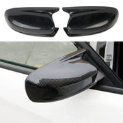 Crosselec front view of mirror cover showing carbon-fiber pattern and sleek finish