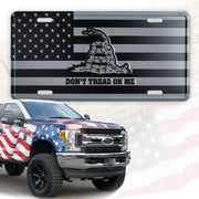 DillenCo front view of grey and black DT license plate showing clear emblem and finish benefit