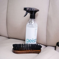 Geist cleaning car seat in use, restoring interior without harsh chemicals