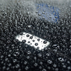 Gyeon Wet Coat on painted panel mid-rinse showing instant gloss and beading
