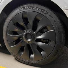 KAVANIC front view of four matte black wheel covers showing modern turbine styling and protection