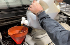 Lisle 19602 pouring oil into engine fill port showing easy access and precise transfer benefit