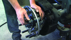 Lisle 28950 beside a lug nut for scale showing compatibility with 22mm studs