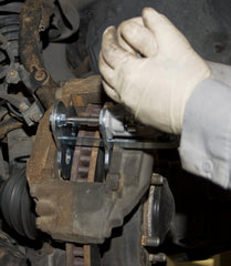 Lisle 29100 in use on caliper illustrating simultaneous piston compression