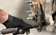 Lisle hub remover in use on vehicle hub, speeds frozen hub extraction safely