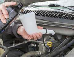 Lisle offset funnel in use pouring brake fluid into master cylinder with no spills