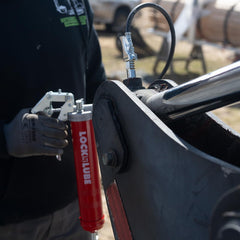 LockNLube grease gun in use on vehicle axle illustrating reach and real-world benefit