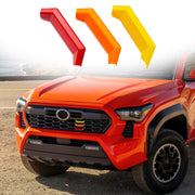 RAVOTOM front grille badge close-up showing colorful trim benefit visibility