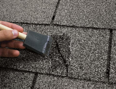Sashco in-use close-up sealing roof flashing with clear, flexible finish
