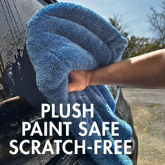 THE HOUSE OF RAGS towel held in hand to show 27.5-inch scale and ease of handling benefit