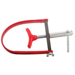 TUSK flywheel holder in use on an ATV rotor, stabilizing the flywheel for controlled removal
