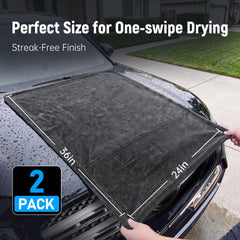 Veco towel held in hand to show 36x24 size for faster drying