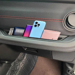 XQTMYHAL holding phone wallet and keys to show organized, reachable storage