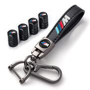XTUPO keychain and valve caps on black surface showcasing branded styling and cohesion