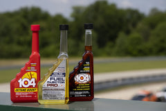 104+ being poured into a car fuel tank demonstrating simple in-tank application benefit