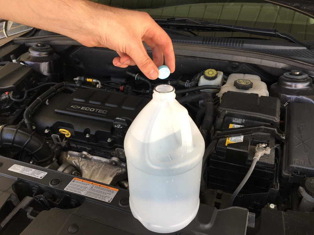 303 Products being used to clean a car windshield, improves visibility benefit