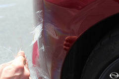 backside adhesive layer of 3M film visible to show strong tack for secure paint bonding