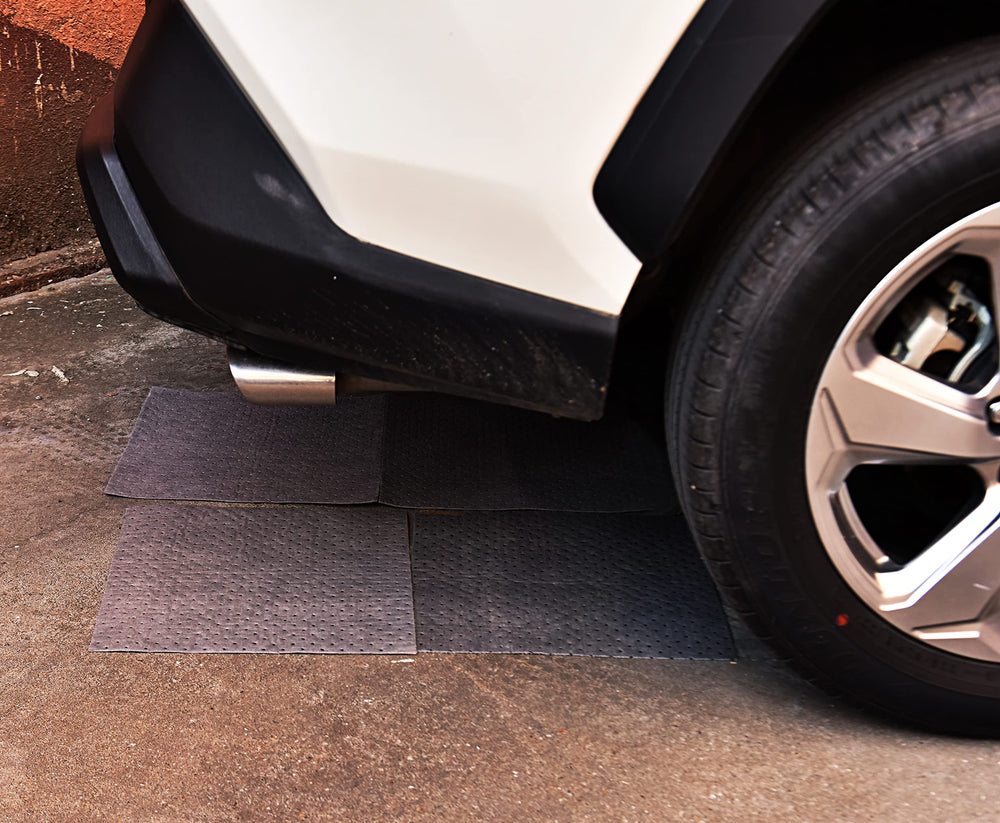 A A IN mat in use under vehicle capturing oil and protecting floor