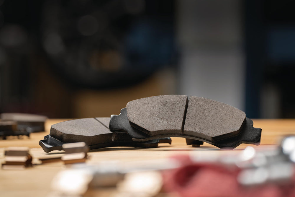 ACDelco pad close‑up highlighting chamfers and slots for quieter braking