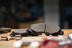 ACDelco pad close‑up highlighting chamfers and slots for quieter braking