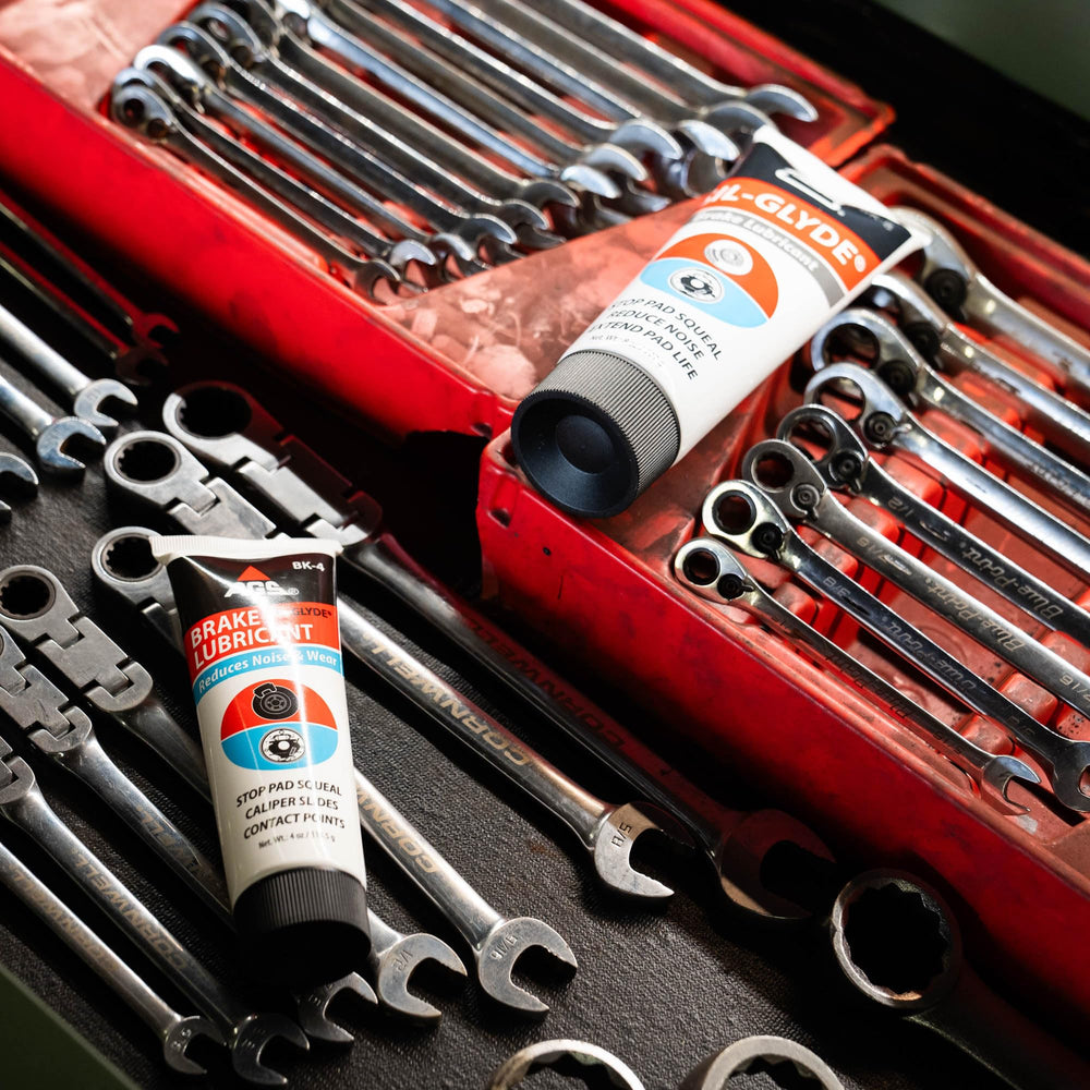 AGS SIL-Glyde on garage workbench with tools showing professional-grade brake service