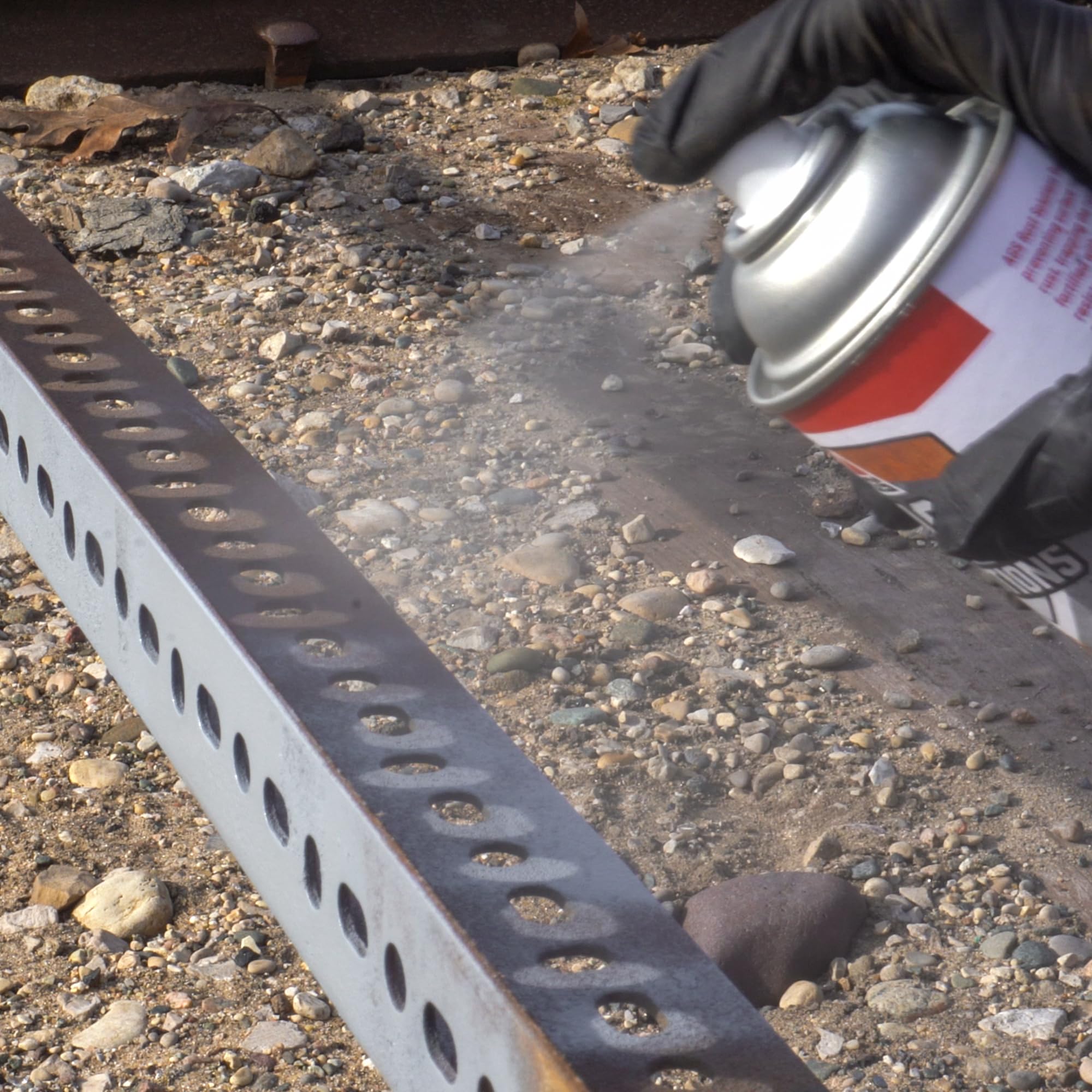 AGS RUST SOLUTIONS spraying on metal railing illustrating fast application and weather protection