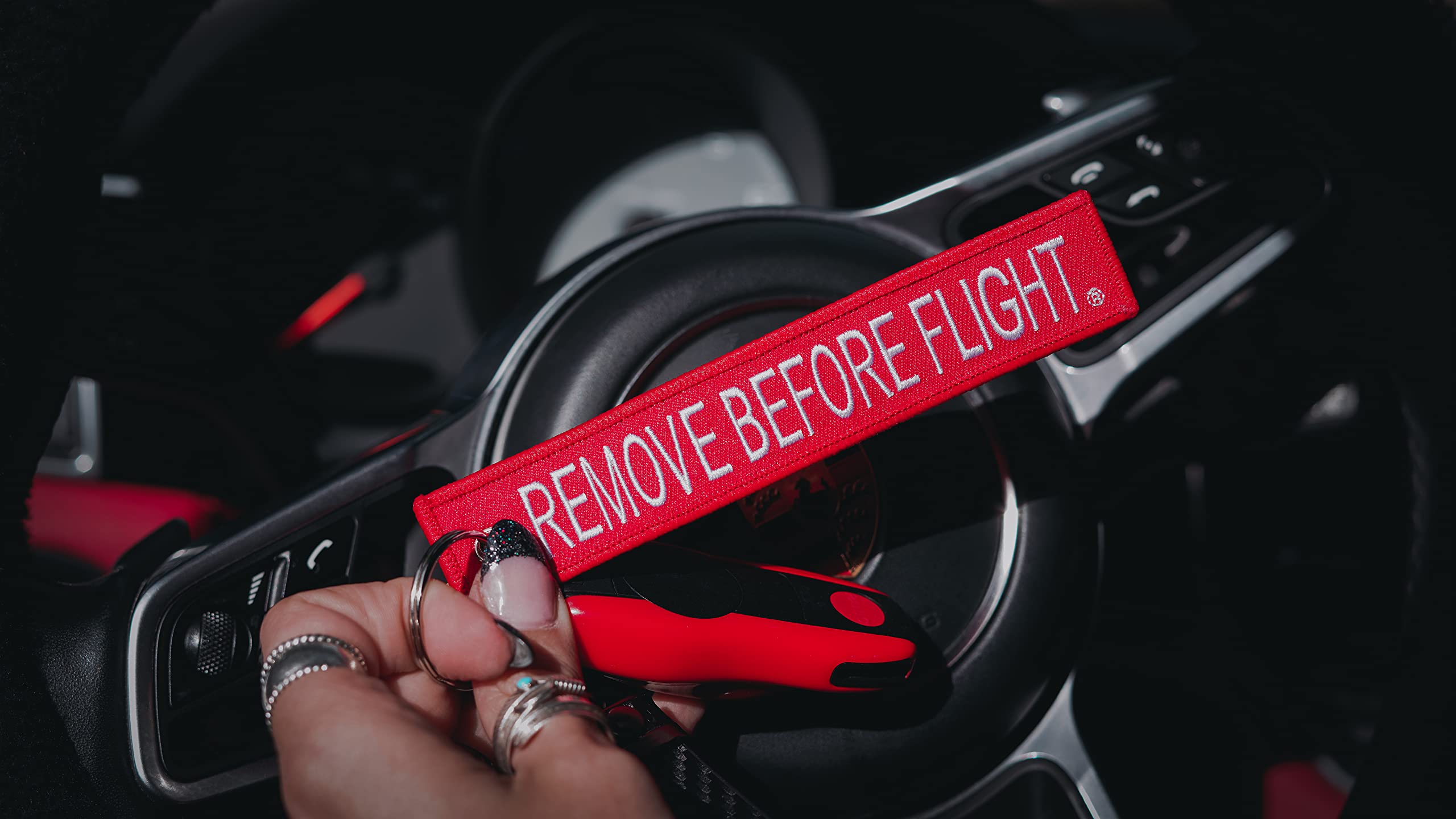 AIXEPA tag attached to backpack strap showing practical travel visibility