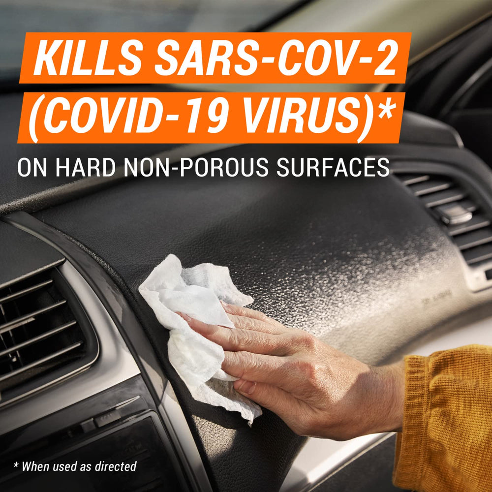 Armor All wiping dashboard to remove dust and provide clean finish