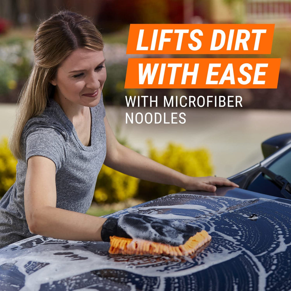 Armor All mitt being rinsed under faucet to remove trapped grit