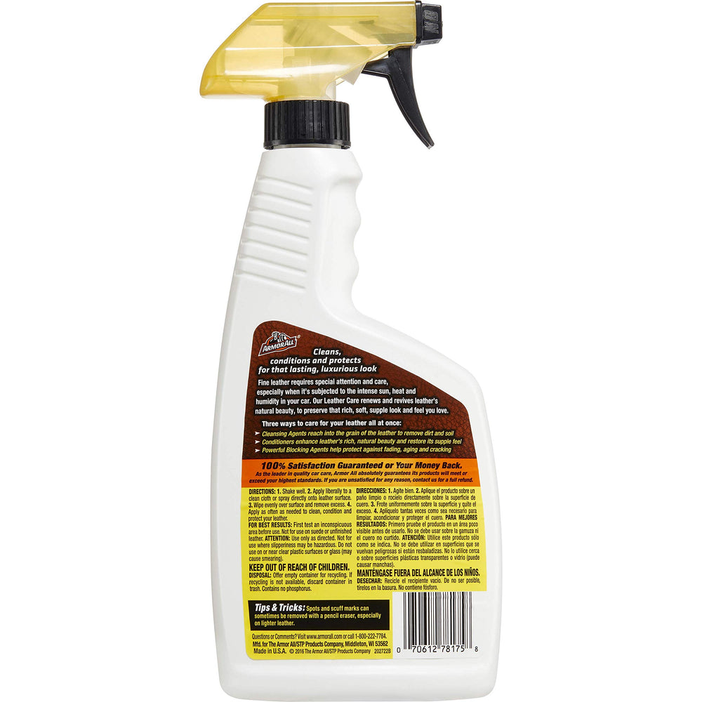 Armor All spray in hand applying cleaner to leather for quick cleaning