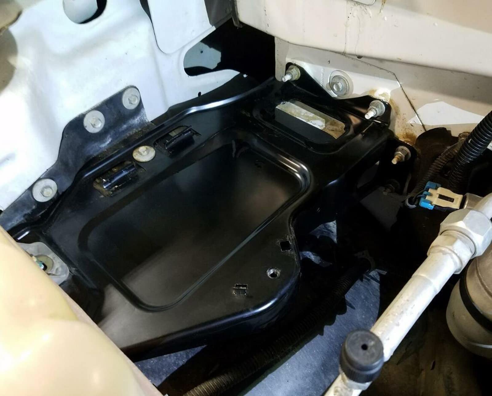 ARONOVA tray installed in vehicle demonstrating correct fit and battery support