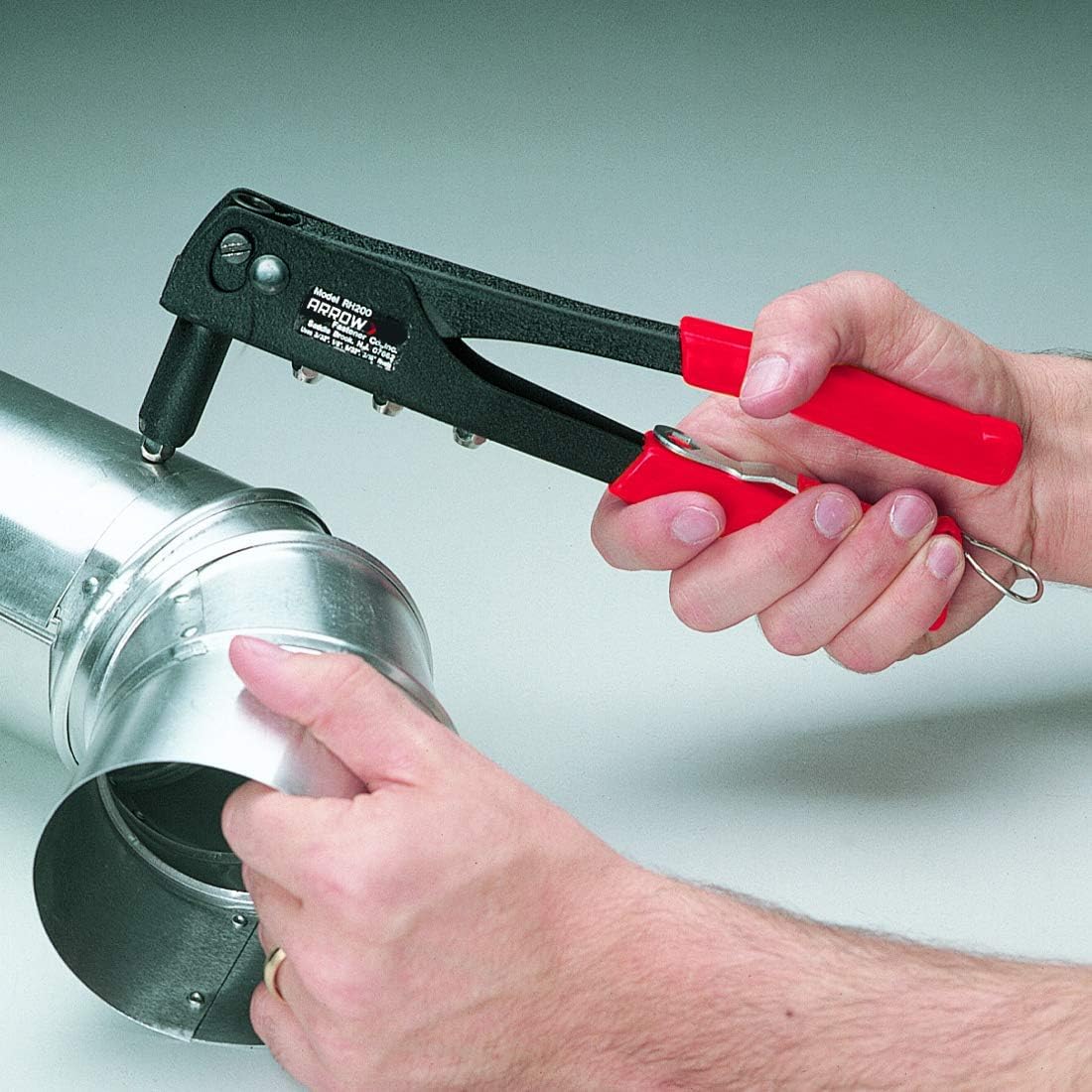 Arrow Fastener riveter on workbench with tools showing workshop readiness