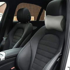 Aukee pillow installed in a car front seat providing neck support while driving