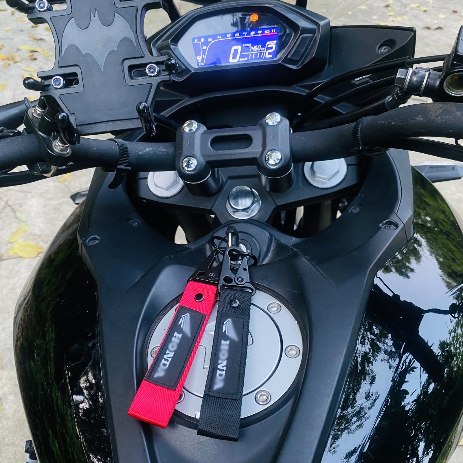 AUSZUOI keychain attached to motorcycle gear illustrating rider-ready convenience