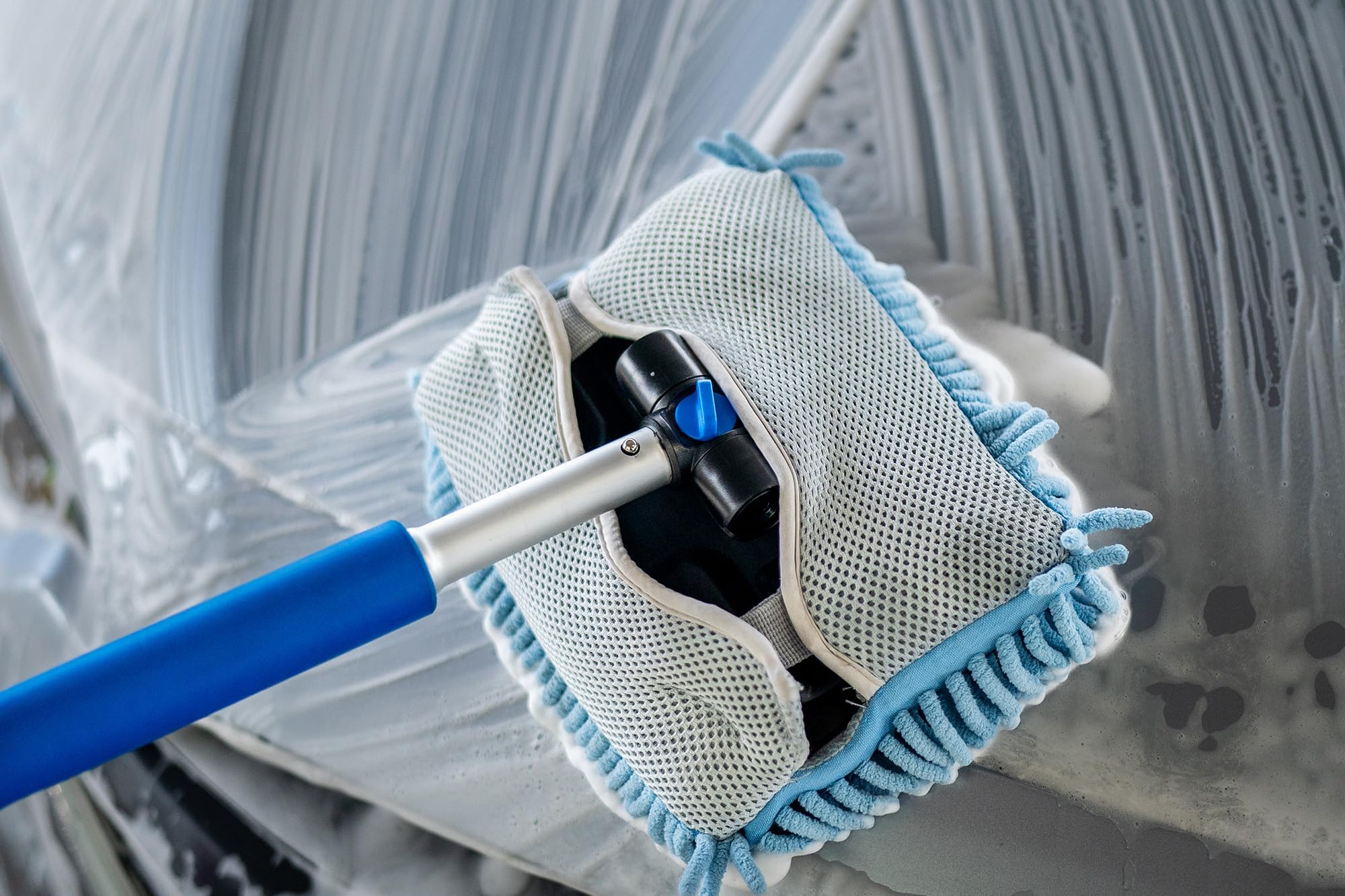 Autofiber mitt on a stick washing a car roof demonstrating safe high-access cleaning