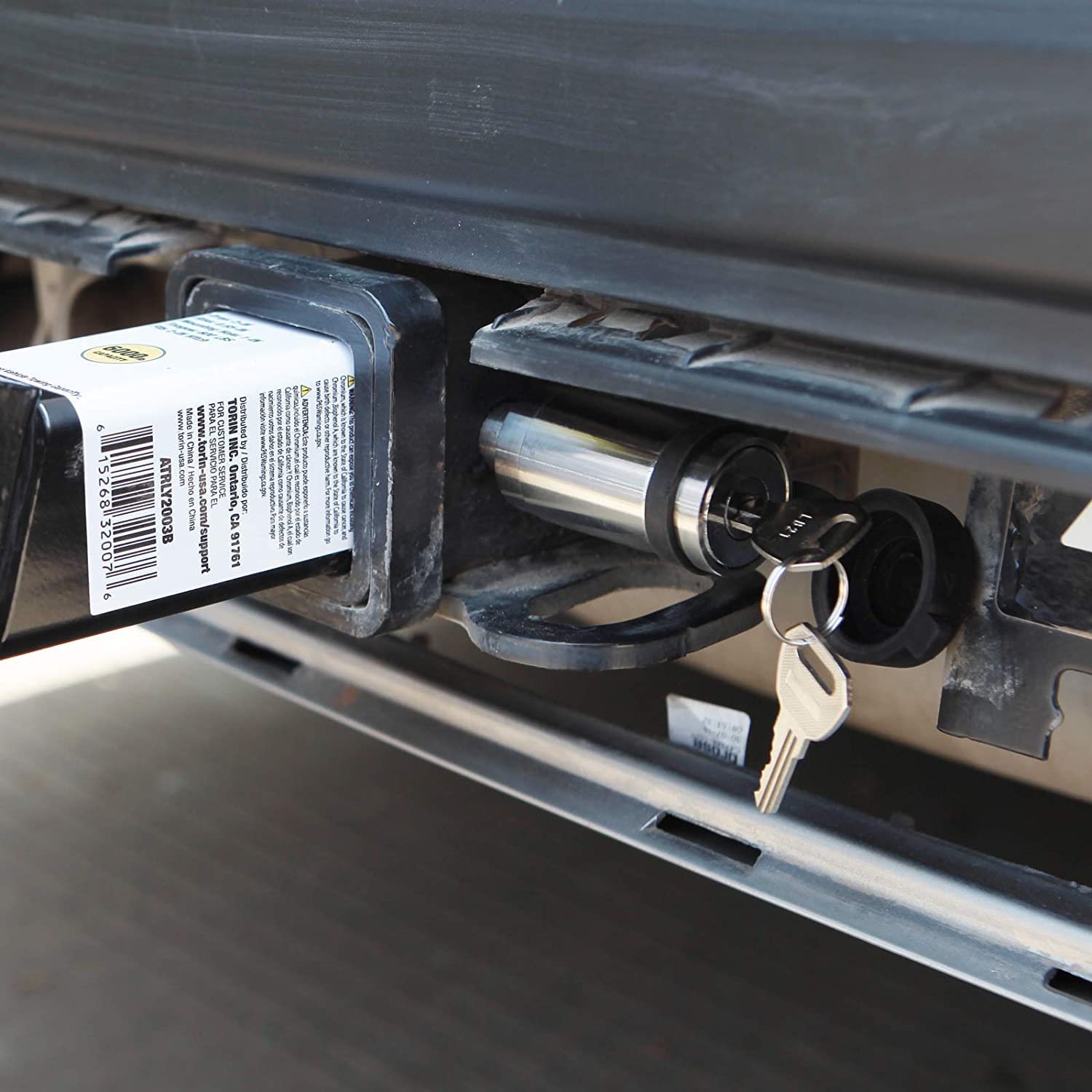 Big RED hitch lock in use on a truck towing trailer showing theft deterrence