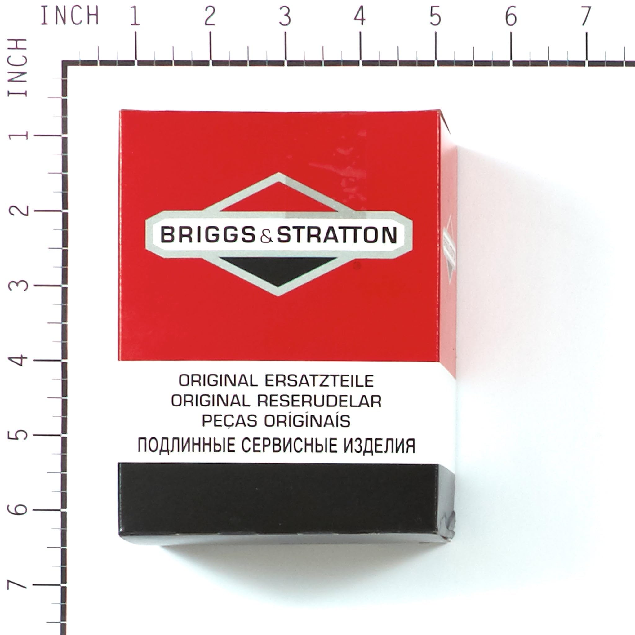 Briggs & Stratton carburetor shown to scale next to a coin for size reference