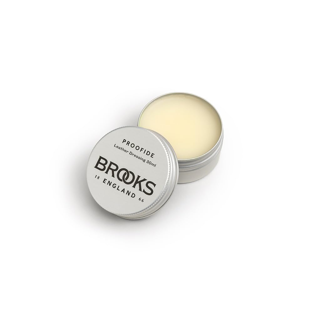 Brooks England Proofide being applied to saddle underside, demonstrating moisture protection benefit