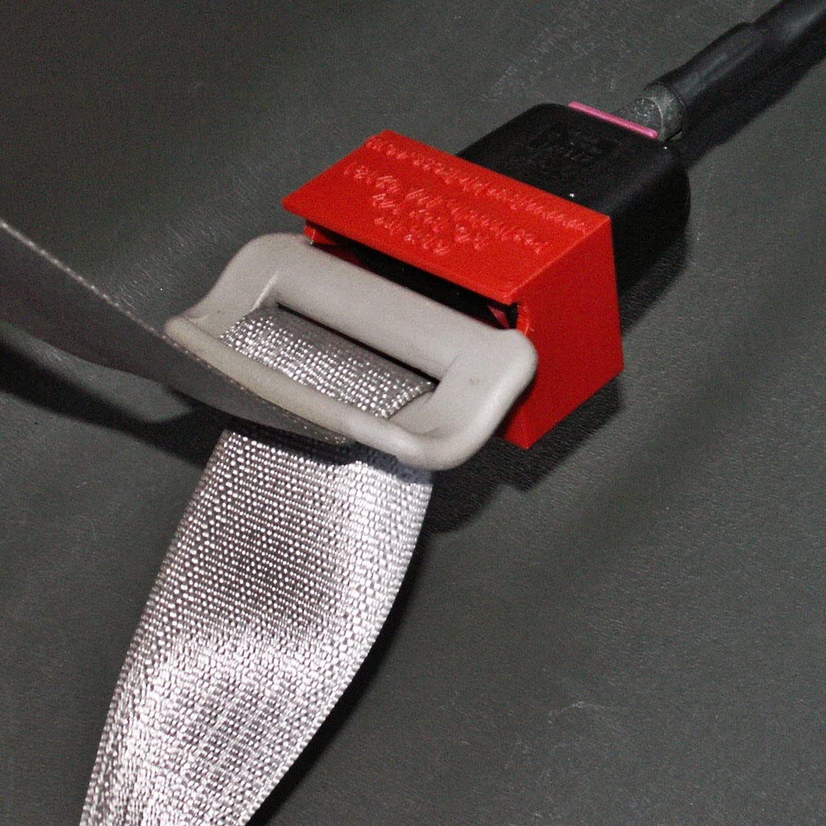 Buckle Boss held in an adult hand to show compact scale and portability