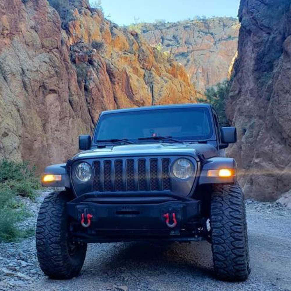BulbForst-equipped Jeep driving on road showcasing modernized look and improved daytime visibility