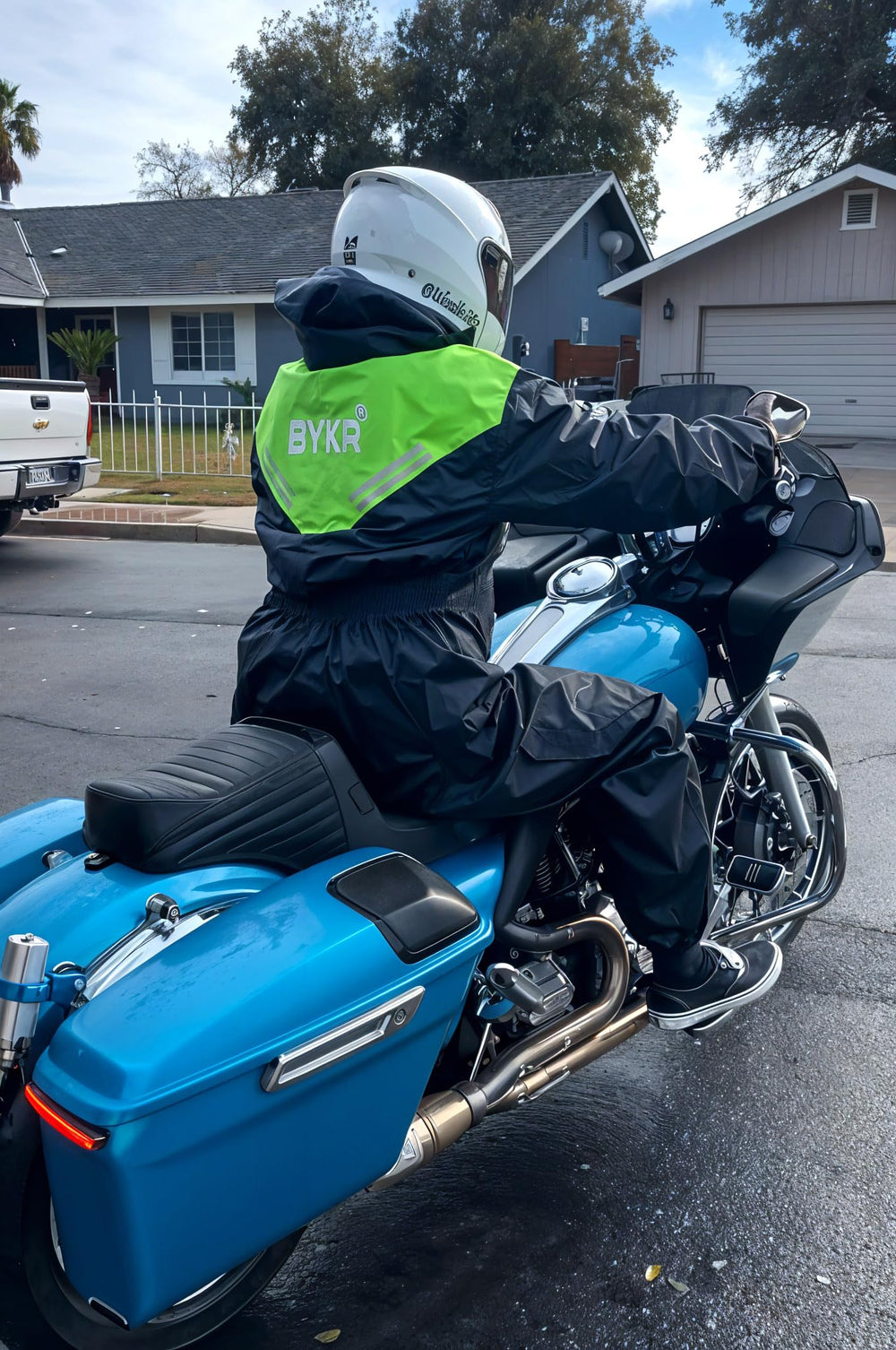 BYKR rider in rain on motorcycle illustrating real-world wet-weather protection