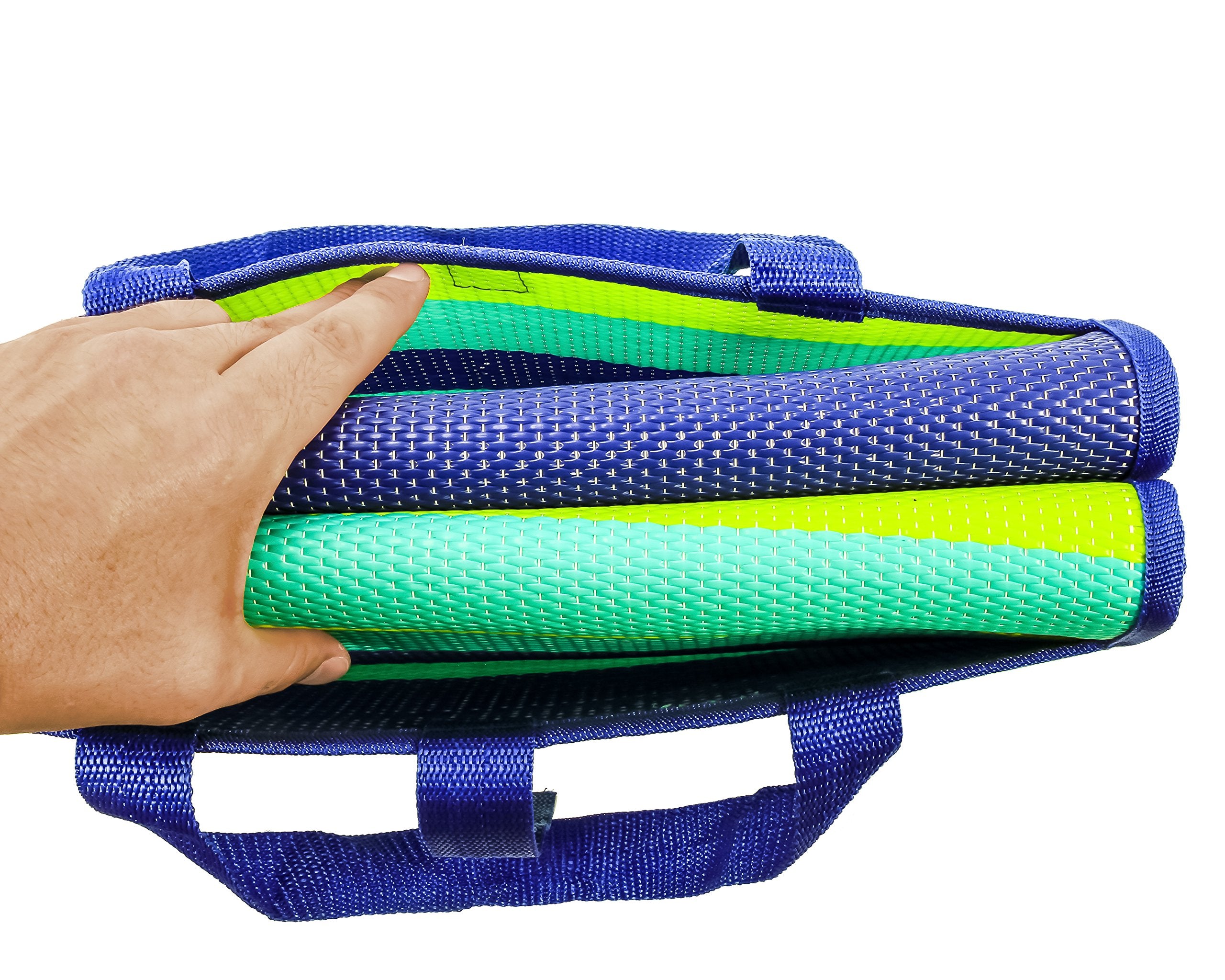 Camco mat folded inside car trunk demonstrating compact travel storage