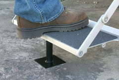 Camco brace installed under camper step, showing eliminated rocking and steadier entry