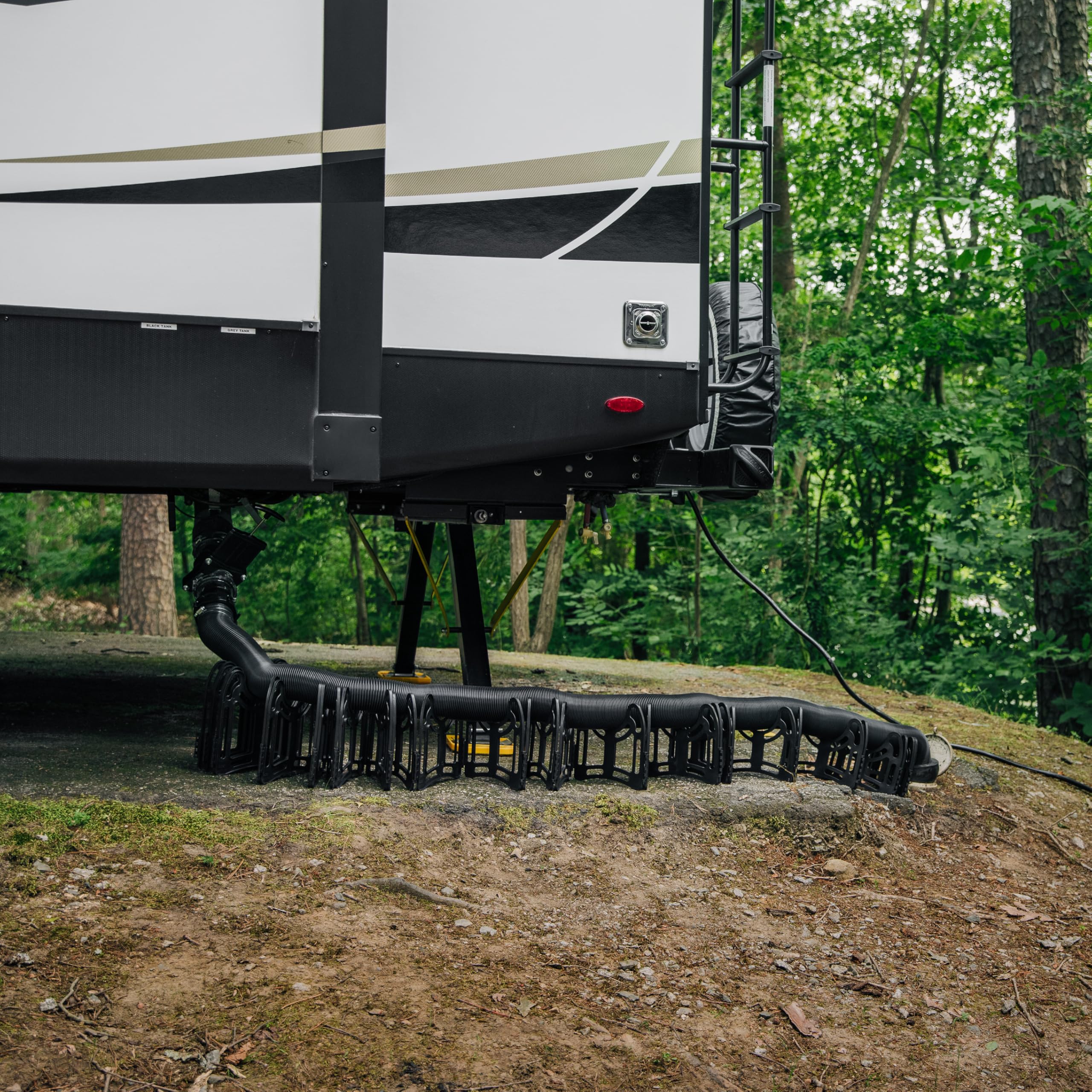 Camco Sidewinder next to boot for scale showing compact 10-foot reach