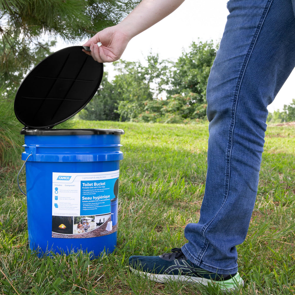 Camco next to a backpack to show compact 5-gallon size and portability